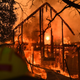The frame of a house still stands as it burns in front of the rising sun during the Kincade Fire in Healdsburg, California on Oct. 27, 2019.